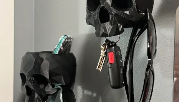 Низкополигональный настенный контейнер с черепом и крюк... Низкополигональный настенный контейнер с черепом и крюк...