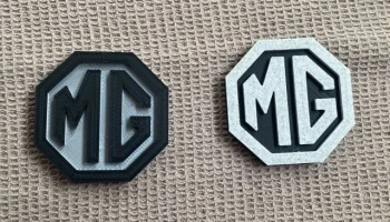 Магнит на холодильник с логотипом MG...... 1